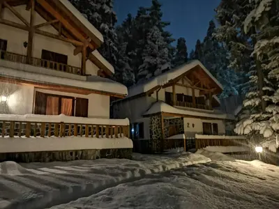 a ski lodge in the snow at night at Saint George Borovets Hotel in Borovets