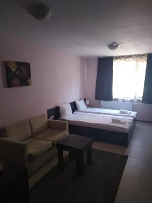 a living room with a large bed and a couch at Maria-Antoaneta Residence in Bansko