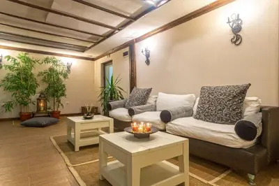 a living room with two couches and two tables at Maria-Antoaneta Residence in Bansko