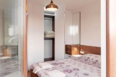 a bedroom with a bed and a mirror at Center apartment with amazing view in Sofia