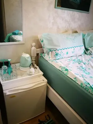 a bedroom with a bed with a mirror and a table at Hotel Paradise in Sofia