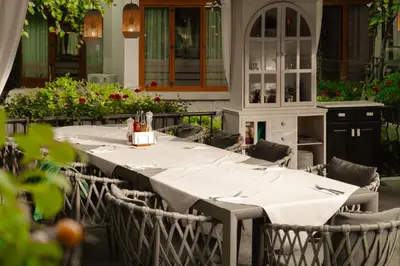 a table with chairs and a white table cloth at Family Hotel Edia-Sandanski in Sandanski