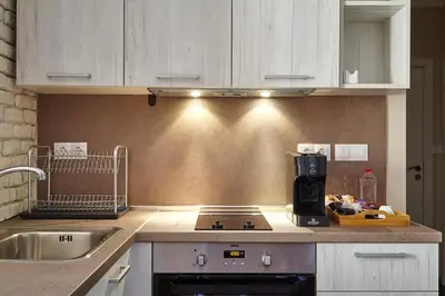 a kitchen with a stove top oven next to a sink at City Center Studio in Plovdiv