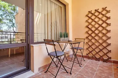 a balcony with a table and chairs and a window at City Center Studio in Plovdiv