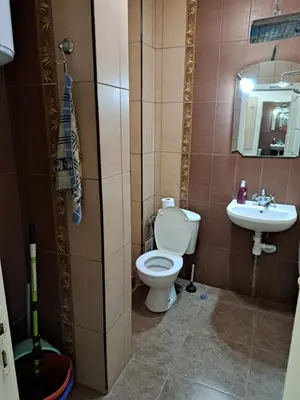 a bathroom with a toilet and a sink at Sun Стамат Икономов 11 in Plovdiv