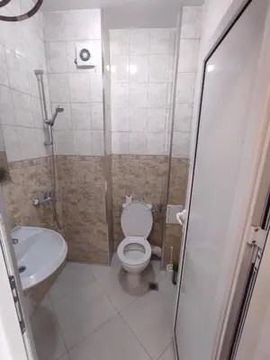 a bathroom with a toilet and a sink at Sun Стамат Икономов 11 in Plovdiv