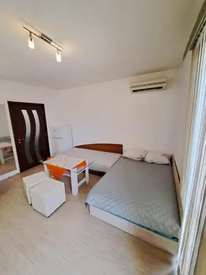 a bedroom with two beds and a table in it at spa in Plovdiv