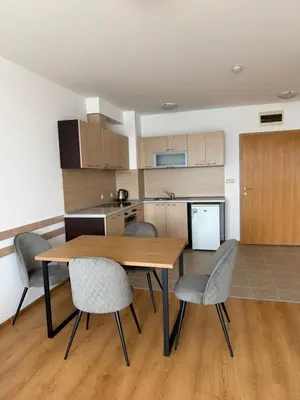 a kitchen and dining room with a wooden table and chairs at Aspen Golf and Ski Resort in Bansko
