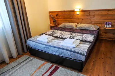 a bedroom with a bed with two towels on it at Guest House Dzhangal in Bansko
