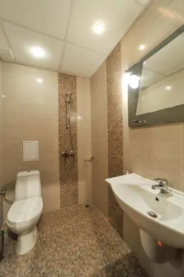 a bathroom with a toilet and a sink and a mirror at Guest House Dzhangal in Bansko