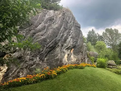 a large rock formation next to a field of flowers at Omaya Eco Village in Gaytaninovo