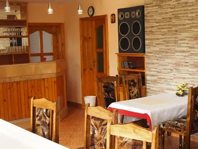 a dining room with a table and chairs at Орбелус in Govedartsi