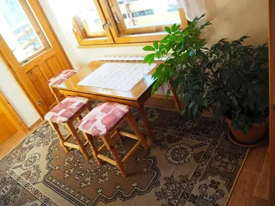 a wooden table with a keyboard and two stools at Орбелус in Govedartsi