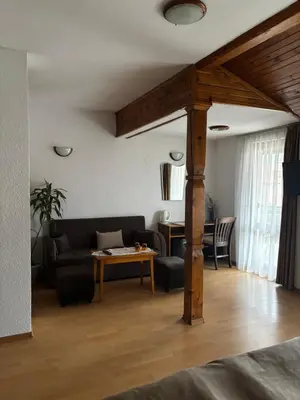 a living room with a couch and a table at Durchova Kashta Family Hotel in Bansko