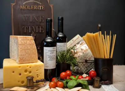 a table with two bottles of wine and cheese at Molerite Complex in Bansko