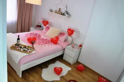 a small bedroom with a bed with hearts on it at Lux Apartment in Pazardzhik