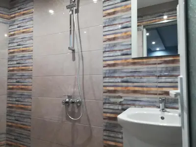 a bathroom with a shower and a toilet and a sink at Къща за гости Мира in Strelcha