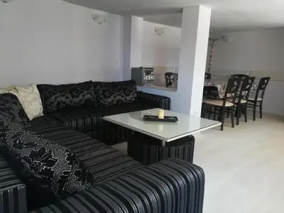 a living room with a couch and a table at Къща за гости Мира in Strelcha