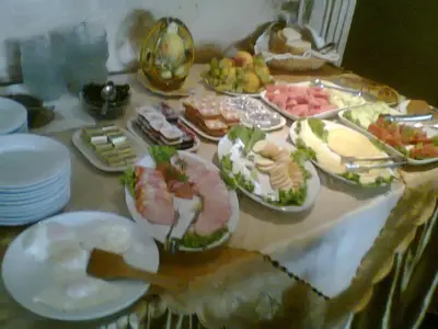 a table with many plates of food on it at Hotel Alafrangite in Plovdiv