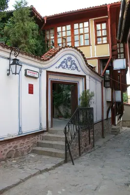 a building with a staircase leading to a door at Hotel Alafrangite in Plovdiv