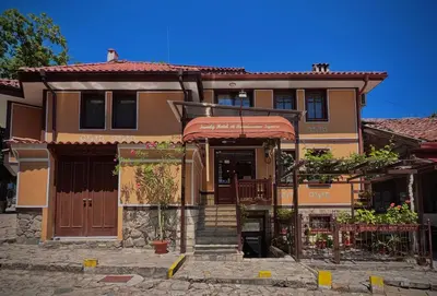 a house with a staircase in front of it at Family Hotel at Renaissance Square in Plovdiv