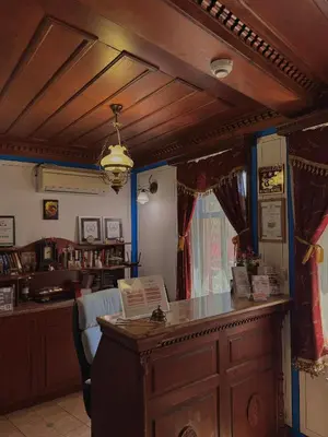 a living room with a bar in a room with at Family Hotel at Renaissance Square in Plovdiv