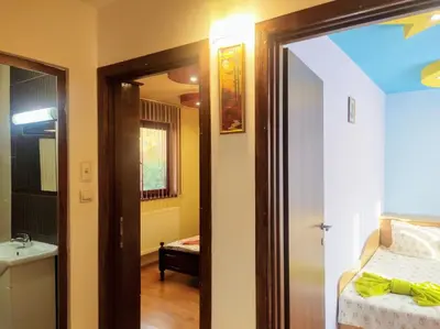 a room with a bathroom with a bed and a sink at Holiday Home Veli in Sapareva Banya