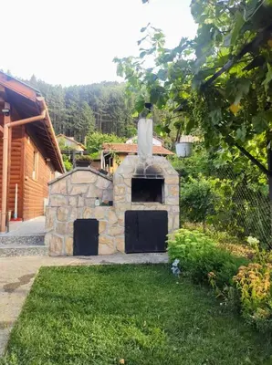 a stone oven in the yard of a house at Holiday Home Veli in Sapareva Banya