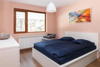 a bedroom with a large blue bed and a window at Апартамент 