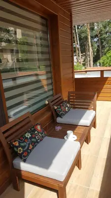 two benches on the porch of a house at Апартамент 