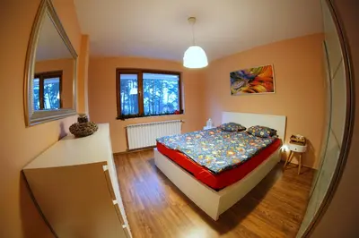 a bedroom with a bed and a large mirror at Апартамент 