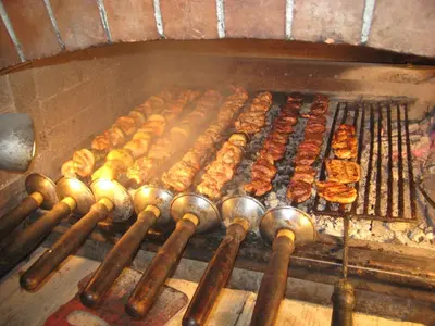 a bunch of food is cooking on a grill at Family Hotel Bunara in Brestnik