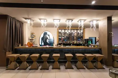 a bar with brown stools in a restaurant at SPS Hotel in Plovdiv