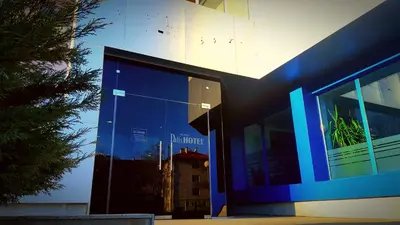 a building with a blue facade with a tree at Family Hotel Dalis in Sofia