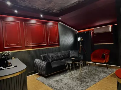 a living room with a black couch and red cabinets at Hotel Allur in Plovdiv