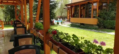 a garden with flowers and plants in a building at Family Hotel Iv in Velingrad