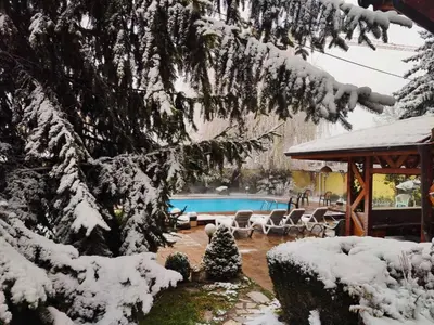 a swimming pool covered in snow in a yard at Family Hotel Iv in Velingrad