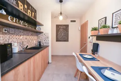 a restaurant with a counter and a table with chairs at Artemis Apartments in Sandanski