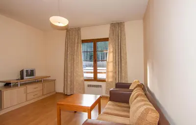 a living room with a couch and a window at Апартаменти Малина in Pamporovo