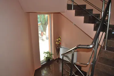 a staircase in a house with a glass window at Hotel Milenium in Sofia