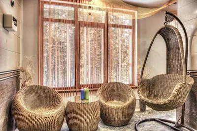 a bathroom with three wicker chairs and a tub at MPM Family Hotel Merryan in Pamporovo