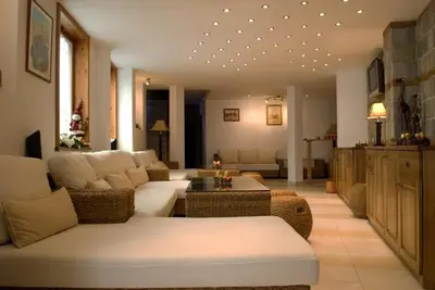 a living room with a couch and a table at Guest House Chicho Tsane in Bansko