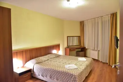 a bedroom with a bed with two towels on it at Apart Hotel Comfort in Bansko