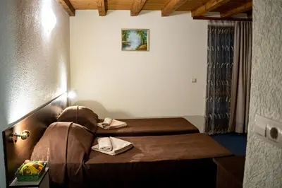 a hotel room with two beds in a room at Matsurev Han in Bansko