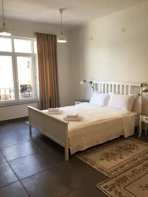 a bedroom with a large bed and a large window at Студия Давидов 