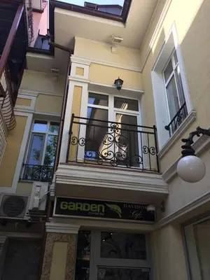 a building with a balcony and a sign on it at Студия Давидов 