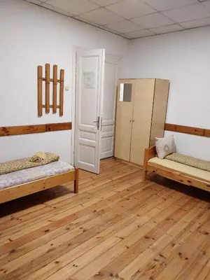 a room with two beds and a refrigerator at Sky Rooms in Sofia