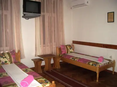 a living room with two beds and a tv at Sky Rooms in Sofia