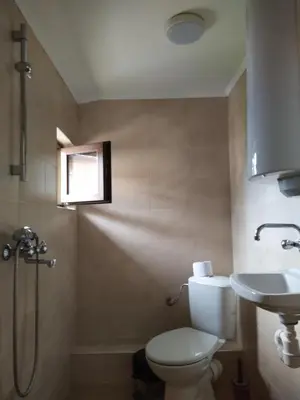 a bathroom with a toilet and a sink at ИВАНЕЛИ in Sapareva Banya