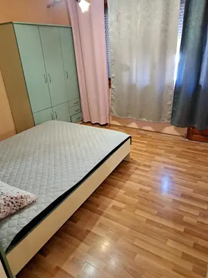 a bedroom with a bed and a wooden floor at relax in Plovdiv